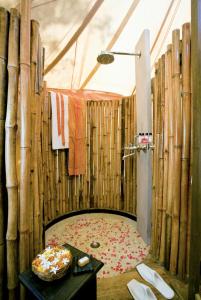 a bathroom with wooden walls and a shower with a table at Khem Villas in Sawāi Mādhopur