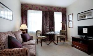 a living room with a couch and a table at Macdonald New Blossoms Hotel in Chester