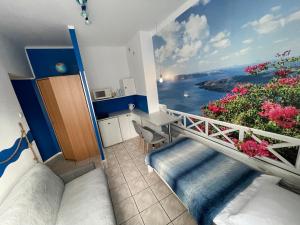 a room with a balcony with a view of the ocean at Apartamenty Konopnicka in Bydgoszcz