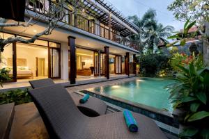 a house with a swimming pool in a yard at Green Oasis Private Villa in Ubud