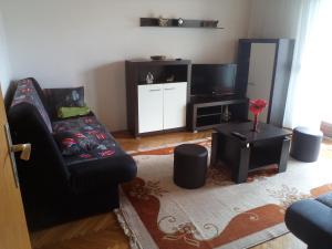 a living room with a couch and a flat screen tv at Apartments with parking space Lopar, Rab - 17436 in Lopar