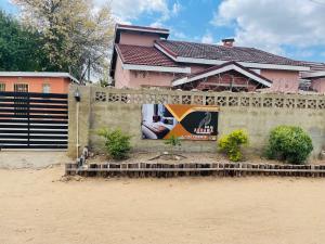 a house with a mural on the side of a wall at Abrama Bed And Breakfast in Francistown