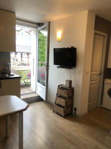 a kitchen with a living room with a tv on a wall at studio 6 Versoie avec parking in Thonon-les-Bains