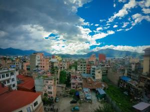 een stad met gebouwen en bergen op de achtergrond bij Hotel Mega & Apartment in Kathmandu