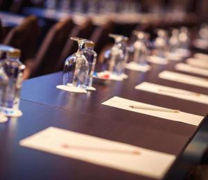 a long table with glasses and napkins on it at The Regent Boutique Hotel & Spa PRE OPENING in San Marino