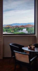 a window in a room with a table and chairs at UrCove by HYATT Beijing Forbidden City in Beijing