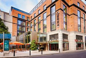 a large brick building on a city street at The Grafton Hotel in Dublin