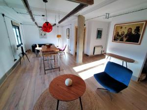 a living room with a blue chair and a table at Lotila Flats Mieres in Mieres