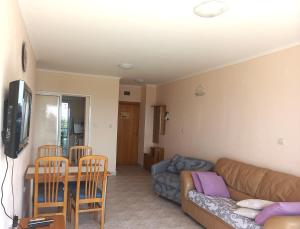 a living room with a couch and a table at Vega Village Ap A8 in Sveti Vlas