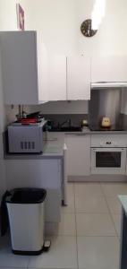 a kitchen with white cabinets and a trash can at mas saint genieis in Canet