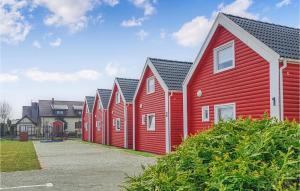 a row of red houses in a row at 2 Bedroom Gorgeous Home In Sianozety in Sianozety