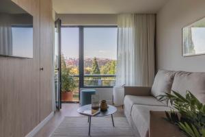 a living room with a couch and a table at Apartamentos Líbere Pamplona Yamaguchi in Pamplona