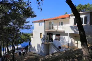 a house on the side of a hill with trees at Rooms with a parking space Brela, Makarska - 17281 in Brela
