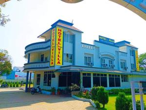 a blue building with a sign in front of it at HOTEL SHREE VILLA in Harsola
