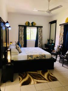 a bedroom with a king sized bed in a room at Cap Jean Marie Beach Villas in Anse Kerlan