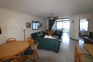 a living room with a couch and a table at Mont Blanc 17 in Margate