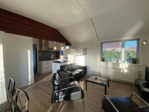 a living room with a couch and a table at Op 't Landtweg 35 in Callantsoog