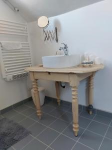 a bathroom with a sink on a wooden table at Maison au pied de la cathédrale Amiens centre in Amiens