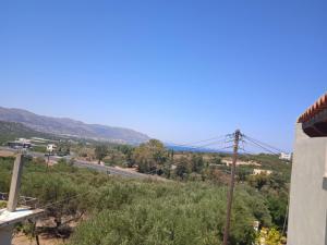 a view of a road with mountains in the background at Malia sea view in Pírgos