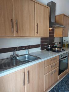 a kitchen with a sink and a stove at Lovely 2 bedroomed flat in the centre of Longton in Longton