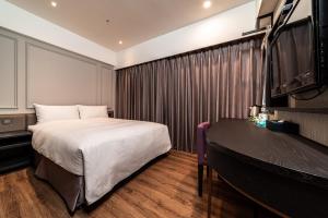 Postel nebo postele na pokoji v ubytování Fish Hotel Kaohsiung