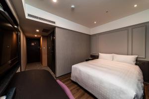 Postel nebo postele na pokoji v ubytování Fish Hotel Kaohsiung