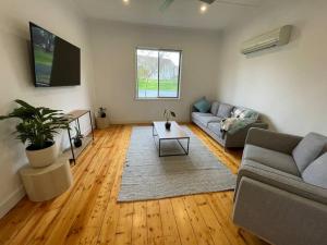 a living room with a couch and a table at Walnut House - Hargreaves St close to Lake Weeroona in Bendigo