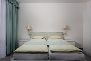 Un ou plusieurs lits dans un hébergement de l'établissement Hotel Ferdinand