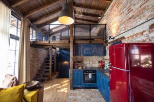 a kitchen with blue cabinets and a red refrigerator at NOMAD STUDIOS, Kapana in Plovdiv