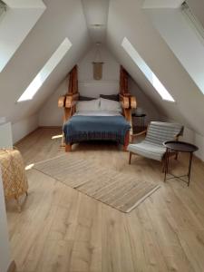 a attic bedroom with a bed and a rug at Apartament 39 in Karpacz