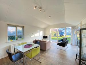 a living room with a table and chairs at Op 't Landtweg 35a in Callantsoog
