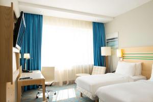 Ένα ή περισσότερα κρεβάτια σε δωμάτιο στο Radisson Blu Chelyabinsk Hotel