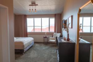 a hotel room with a bed and a desk and window at Hotel Kaldi in Litli-Árskógssandur