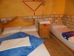 Postel nebo postele na pokoji v ubytování Les Pyramides Hotel Merzouga