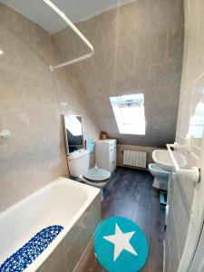 a bathroom with a tub and a toilet and a sink at Duplex con piscina muy cerca de la playa in Santiuste