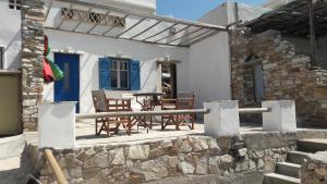 eine Terrasse mit Stühlen und einem Tisch vor einem Haus in der Unterkunft home on the AGAPIANI sea in Kollimpithra