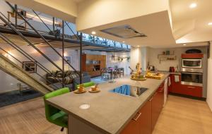 a kitchen with a large island with a counter top at Le Loft Nautilus - Maison Brasseurs d'Etoiles in Liège