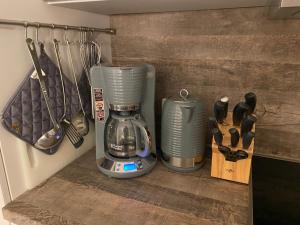 a coffee maker is sitting on a shelf in a kitchen at "Am Yachthafen" in Seedorf