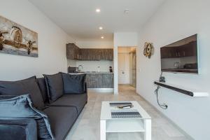 a living room with a couch and a table at Cozy Penthousestudio Cityview W12 in Bucharest +25 photos