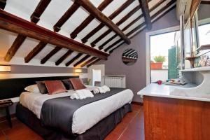 a bedroom with a large bed and a sink at Campo de Fiori in Rome