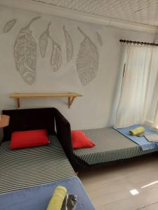 a room with two beds and a couch in it at TAXİM HOSTEL in Istanbul