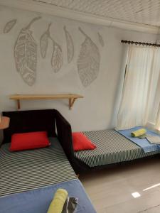 a room with two beds and a couch in it at TAXİM HOSTEL in Istanbul
