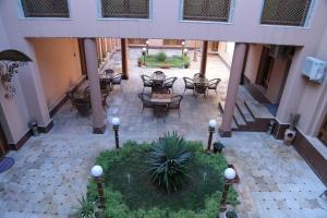 an overhead view of a courtyard with tables and chairs at Rangrez Hotel in Bukhara