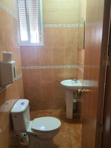 uma casa de banho com um WC e um lavatório em La redonda em San Roque