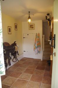 a hallway with a staircase and a room with a table at The Georgian Coach House:New Forest with hot tub in Fordingbridge