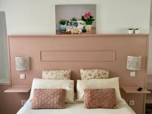 a bedroom with a bed with two pillows and a mantle at La Casita de Las Palmas VV in Las Palmas de Gran Canaria