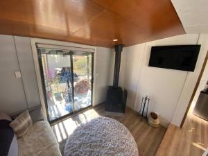 an aerial view of a living room with a fireplace at ReThynk Unique Tiny home East Jindabyne in Jindabyne
