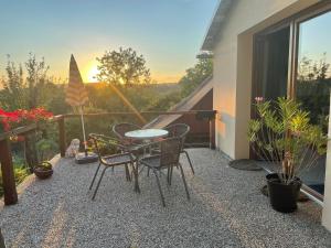 un patio con tavolo e sedie su un balcone di Apartmán v podhůří Jizerských hor a Železný Brod