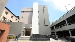 a building with a white column in front of it at Mini Hotel 141 in Gyeongju