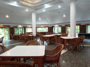 a dining room filled with tables and chairs at Ellora Heritage Resort in Ellora